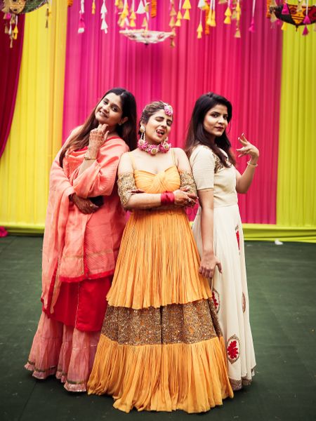 Bride on mehendi day with her bridesmaids 