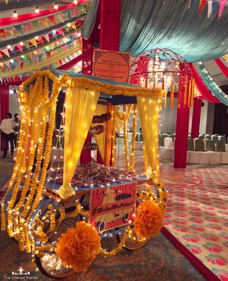 Photo of Mehendi favour cart with genda phool decor and fairy lights