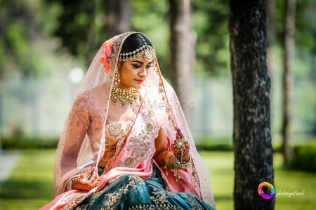 A bride in a contrasting blouse with her lehenga
