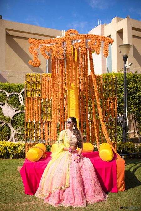 Photo of A bride in a light pink lehenga for her mehndi ceremony