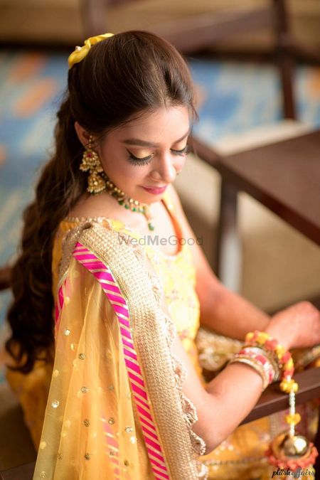 Mehendi bridal look in yellow and pink outfit 