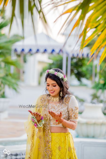 Photo of Bride looking down at her mehendi hands