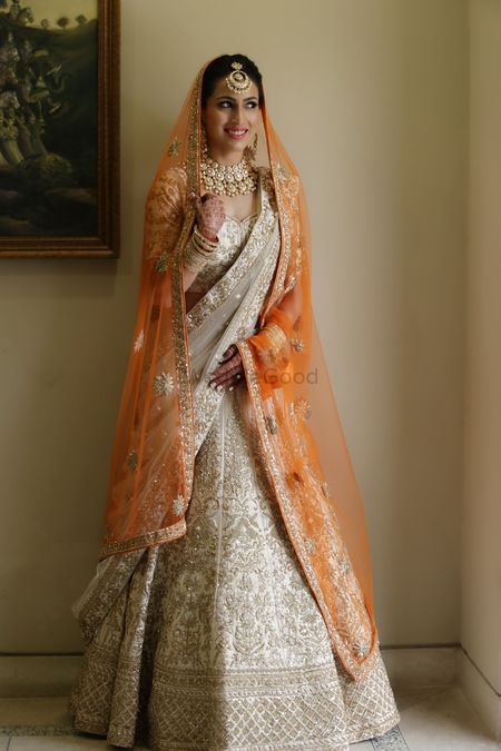 Photo of A bride in a uniquely colored bridal lehenga with a double dupatta