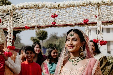 Bride entering under phoolon ka chadar