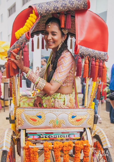 Mehendi fun bridal portrait with bride sitting on rickshaw