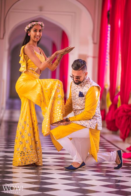 A couple in coordinated yellow outfits for their mehndi