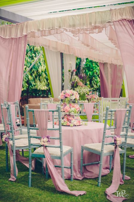 Soft pink table decor with drapes and flowers