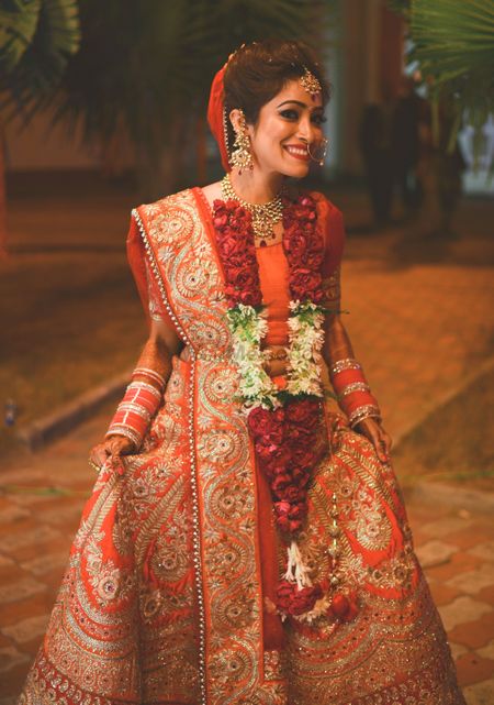 Photo of Happy Bride wearing Red Lehenga