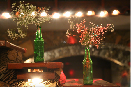 Photo of Green Bottles as Floral Vase with Fairy Lights Decor