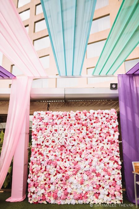 Floral wall decor idea with saying and drapes