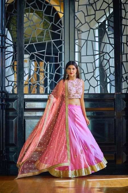 Light pink lehenga with peach dupatta and embellished blouse