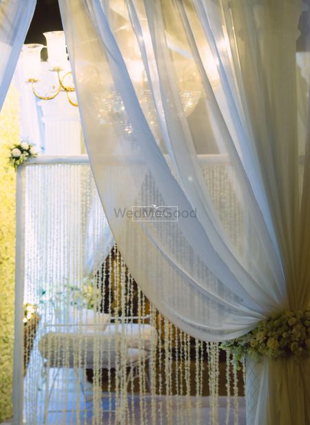Photo of White Curtain Drapes with Floral Decor