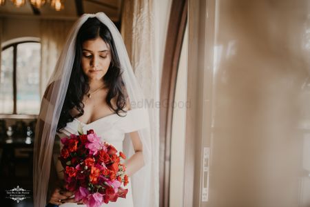 Photo of Christian wedding bride holding a red bouquet