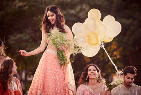 A bride in a shimmer, sequined lehenga with her bridesmaids