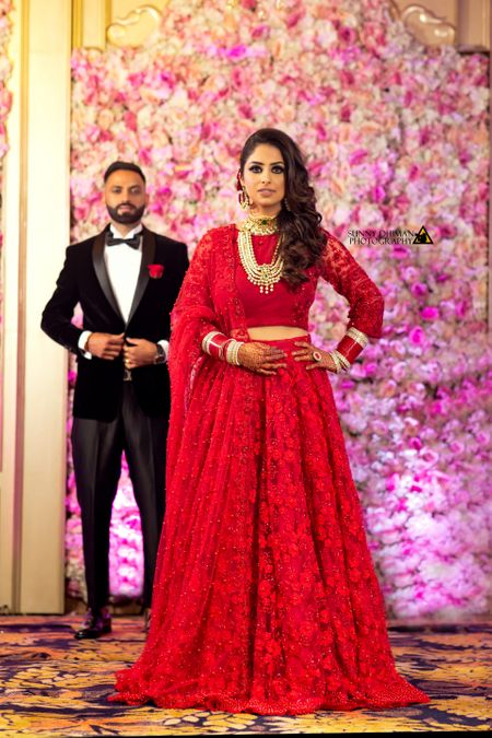 Bride in red lace lehenga for reception