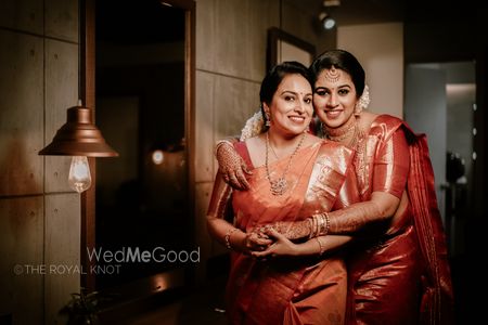 A bride and her mother in coordinated outfits for the wedding