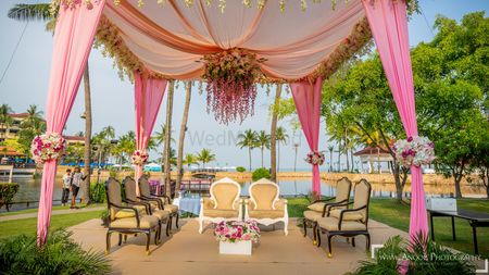 Photo of An open mandap with floral strings and drapes 