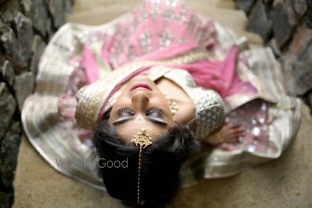 Photo of Pink and Silver Lehenga with Gold Maangtikka