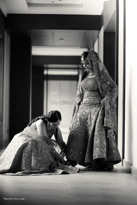 Bride getting help from her sister on her wedding day. 