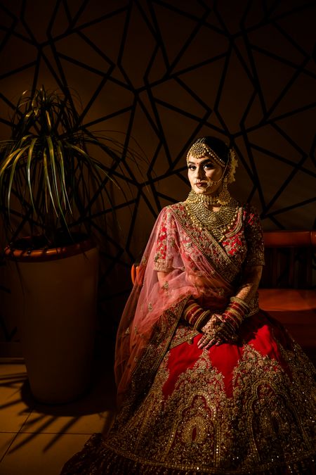 Bride in red and gold lehenga bridal portrait 