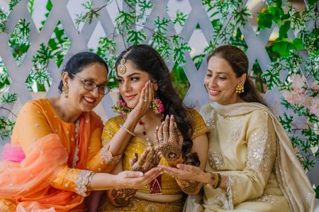 Bridal portrait with her mom and sister on mehendi