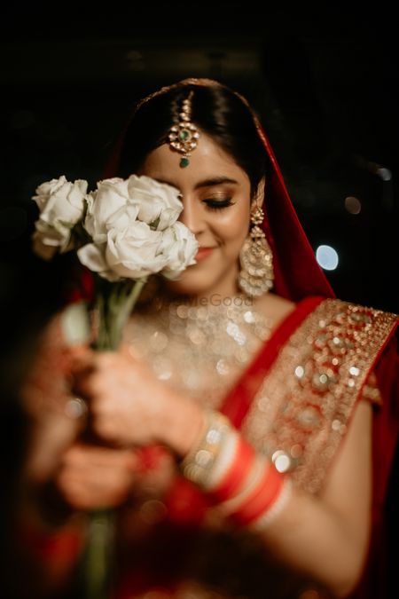 Bridal portrait with red and gold bridal makeup