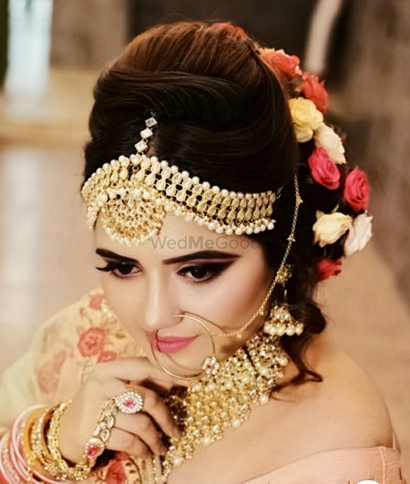 Photo of A beautiful bride with subtle makeup and flowers in hair.