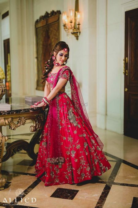 Red and pink mehendi lehenga with floral jewellery