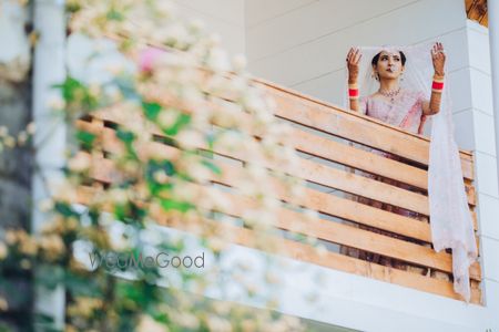 Bridal portrait with a veil on the balcony