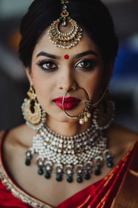 South indian fusion bridal look wearing nath