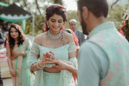 Elegant outdoor engagement with light blue off shoulder lehenga 