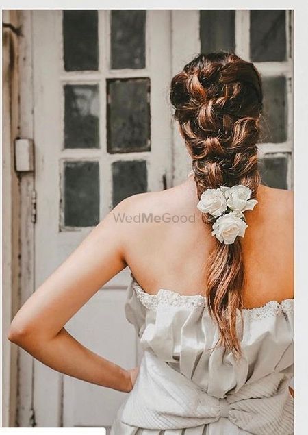 A Christian bride in a braid with roses