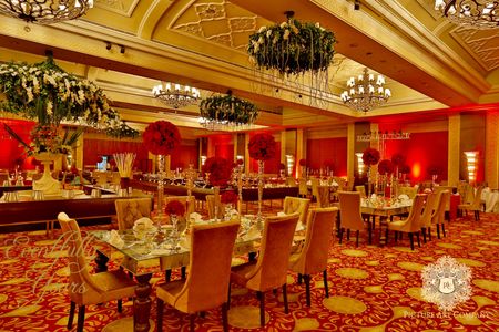 Photo of Red and Gold Theme Decor with Floral Chandeliers