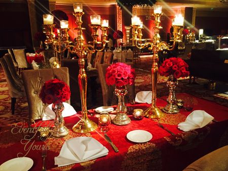 Photo of Red and Gold Themed Decor with Roses