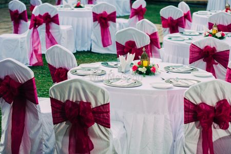 Photo of White and Pink Table Decor with Bow Chairbacks