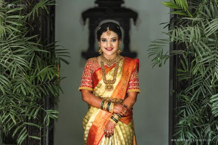 Photo of A south Indian bride in a kanjeevaram saree and temple jewellery