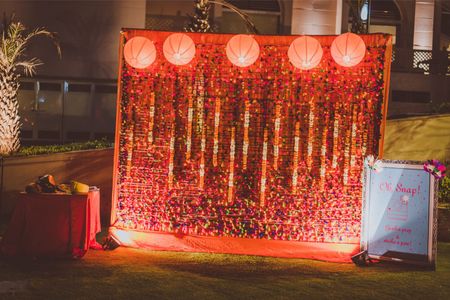 Photo of Orange Floral Photobooth with Lamp Balls