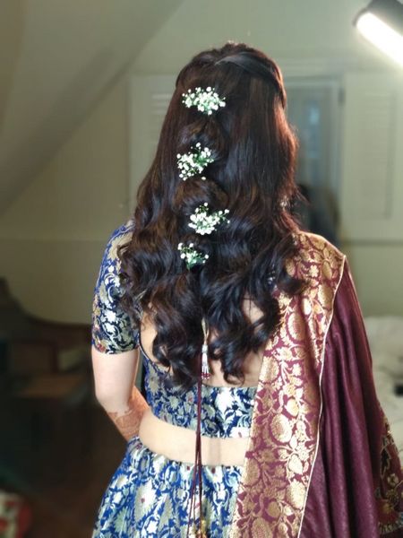 A bride flaunting her soft curls with hair 