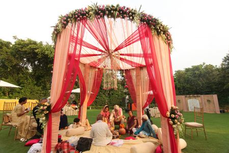 Photo of Red and Cream Mandap with Floral Chandelier