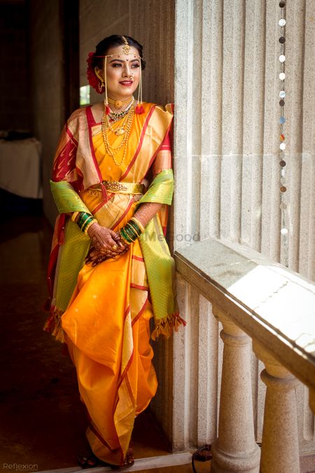 A Marathi bride in a yellow saree with red border 