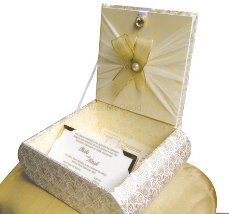 Photo of elegant girl side white and gold invitation box