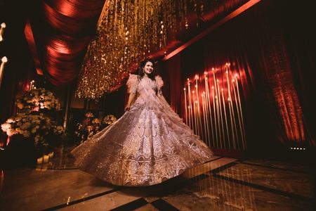 A bride twirling in a metallic lehenga on her reception