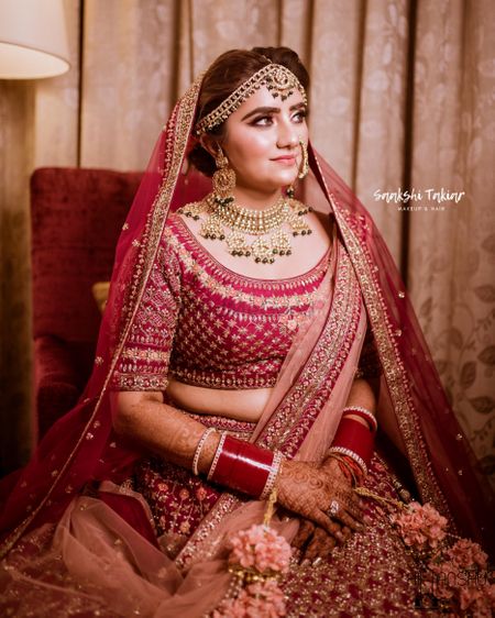 Photo of A bride in red and gold on her wedding day