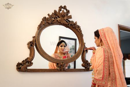 Peach Bride Looking Through The Mirror Shot