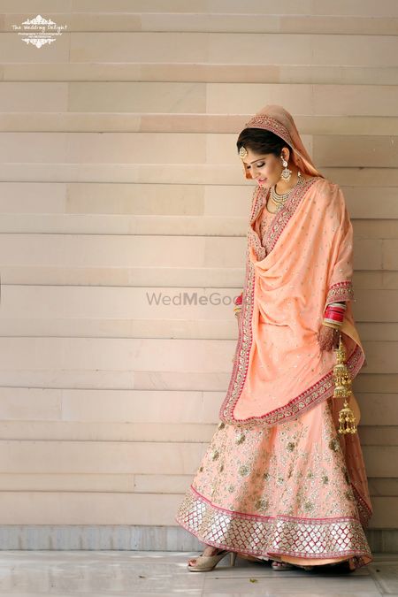 Photo of Pastel Peach Lehenga with Gold Floral Motifs