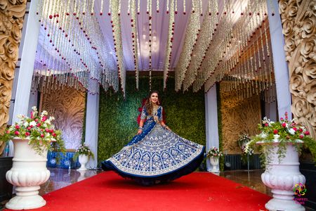 bride twirling in a royal blue lehenga