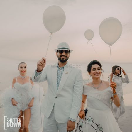 beach wedding idea with couple entry holding balloons 