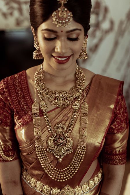 gold bridal look with layered temple necklaces