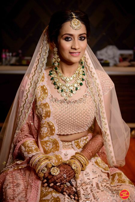 simple pastel bridal lehenga with contrasting jewellery
