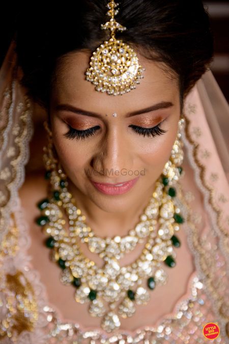 Photo of pastel bridal makeup and contrasting jewellery